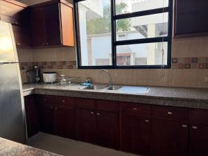 a kitchen with a sink and a window at Enchanted Haven in Puerto Baquerizo Moreno +43 photos