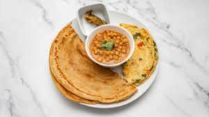 a plate of chapati with a bowl of soup on it at Comfort Lodge in Karachi