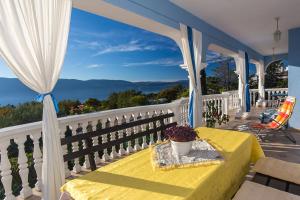 een tafel op een balkon met uitzicht op de oceaan bij Apartments Juras in Brzac