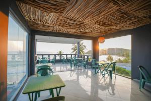 a restaurant with tables and chairs and a view of the ocean at Moringa Beach in Mirissa