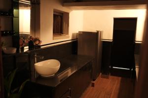 a bathroom with a sink and a toilet on a counter at Periyaveettil Heritage in Neyyāttinkara