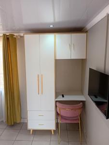 a room with a white cabinet and a desk at Ashdown BnB in Pietermaritzburg +17 photos