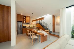 a kitchen and dining room with a table and a couch at Sawo Villa Canggu - Private Brand New 2BR Villa in Canggu