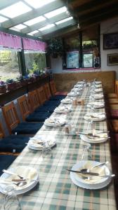 una mesa larga con platos y servilletas. en Farm stay Lackovic en Bilje