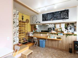 a coffee shop with a chalkboard on the wall at Guesthouse&Café Deep in Kōzushima