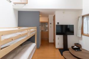 a room with a bunk bed and a flat screen tv at Suncity Hakata in Hakata +33 photos