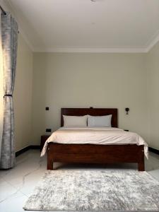 a bedroom with a bed and a rug at Sunset Hideout Kulambiro in Kampala