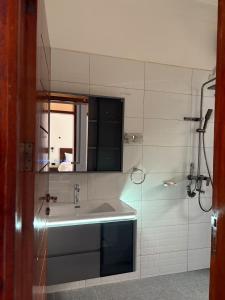 a bathroom with a sink and a mirror at Sunset Hideout Kulambiro in Kampala +24 photos
