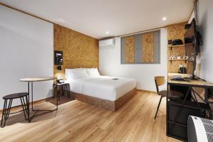 a hotel room with a bed and a desk at Just Sleep Hotel Jihaeng Station in Tongduch'ŏn