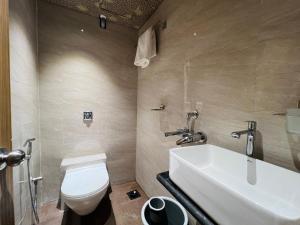a bathroom with a white toilet and a sink at Hotel Imperial Suite-Near BKC in Mumbai +25 photos