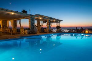 a swimming pool with a sunset in the background at Sunset View Hotel in Parikia