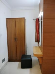 a bathroom with a wooden cabinet and a desk at Sun Classic Residency in Chennai
