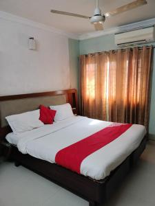 a bedroom with a large bed with a red blanket at Sun Classic Residency in Chennai