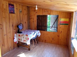 a room with a table and a window in a cabin at Ti caze memé étage in Saint-Philippe