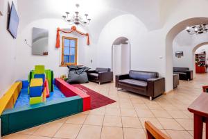 a living room with a colorful couch and chairs at Hotel Belcredi in Brno