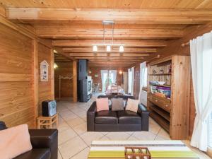 a living room with a couch and a table at Chalet in Vosges with Sauna & Panoramic Views in Anould