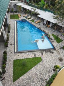 an overhead view of a swimming pool with people in it at The Lavish Haven in Piyadigama +14 photos