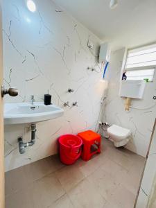 a bathroom with a sink and a toilet at Book the Entire Villa or Choose a Room for a Comfortable Homestay Experience in Solapur