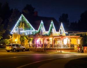 a house is decorated with christmas lights at Auberge Au Soleil Levant in Piopolis