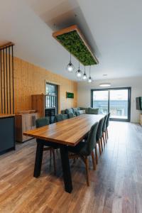 a large dining room with a table and chairs at Rezidence U Hájenky 434 in Lipno nad Vltavou