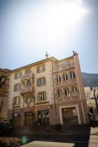 a large tan building with windows on a street at Bed and Breakfast Sweet Home in Tirano