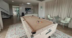 a pool table with balls on top of it in a room at Sea Flower Onsen in Ban Bo Khaem