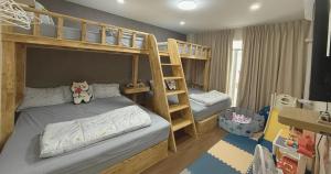 a childs bedroom with bunk beds and a ladder at Sea Flower Onsen in Ban Bo Khaem
