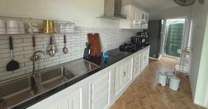 a kitchen with a sink and a counter top at Sea Flower Onsen in Ban Bo Khaem