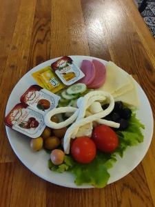 a plate of food with vegetables and cheese on a table at Sofia Corner Hotel in Istanbul +72 photos