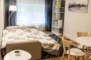 1 dormitorio con 1 cama, mesa y sillas en Elizabetes Apartments, en Riga