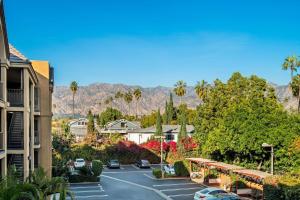 a view of a parking lot with mountains in the background at Howard Johnson by Wyndham Pasadena in Pasadena