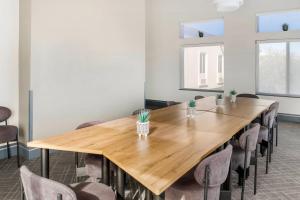 a conference room with a wooden table and chairs at Comfort Inn & Suites El Paso I-10 Airport Area in El Paso
