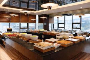 a buffet line with many different types of food at Ramada Encore by Wyndham Busan Station in Busan