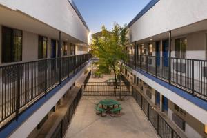 an empty hallway of an apartment building with a table at Travelodge by Wyndham Albuquerque West in Albuquerque