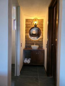 a bathroom with a sink and a mirror at cabañas el rio alcatraz in Zacatlán