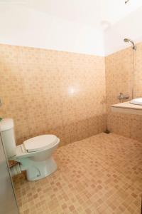 a bathroom with a toilet and a sink at Hill Paradise Nuwaraeliya in Nuwara Eliya