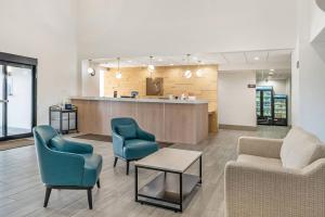 a waiting room with two chairs and a table at Comfort Inn & Suites Madison East Interstate I-90 in Madison