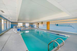a large swimming pool in a building at Comfort Inn & Suites Madison East Interstate I-90 in Madison