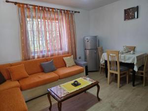 a living room with a couch and a table at Garden Home near Osum Canyon & Cooking Experience in Çorovodë
