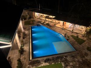 an overhead view of a swimming pool at night at The Lavish Haven in Piyadigama