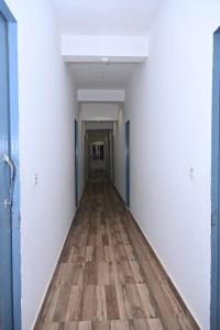 an empty corridor in an office building with a wooden floor at Nirmala Garden in Bamiana