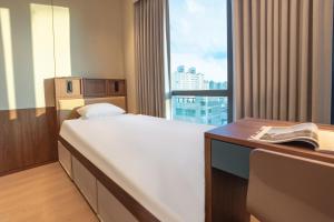 a room with a bed and a desk and a window at Weave Suites - Sunyu Parkside in Seoul +32 photos