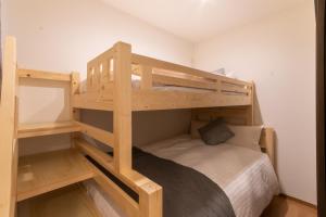 a bedroom with two bunk beds and a bed at Rojuman Hakata in Hakata