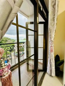 a room with a window with a view of a balcony at STUDIO WITH BALCONY at the HEART of DAVAO CITY in Davao City