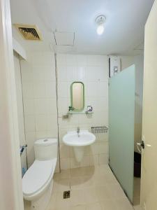 a bathroom with a toilet and a sink at STUDIO WITH BALCONY at the HEART of DAVAO CITY in Davao City +11 photos
