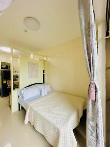 a bedroom with a bed with a mosquito net at STUDIO WITH BALCONY at the HEART of DAVAO CITY in Davao City