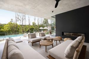 a living room with a couch and a fireplace at Latitude 156 - Elevated Luxury Overlooking the Greens in Doonan