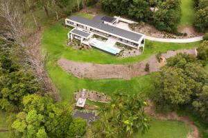 an aerial view of a large house with a yard at Latitude 156 - Elevated Luxury Overlooking the Greens in Doonan +50 photos
