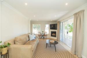 a living room with a couch and a table at Brooklands Sanctuary in Gqeberha