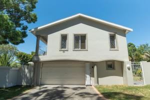 a white house with a garage at Brooklands Sanctuary in Gqeberha